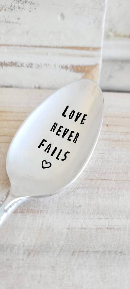 Love never fails hand stamped vintage silver plated teaspoon. It will be placed in a beautiful felt bag along with a waterproof sticker.