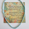 Turquoise beaded bracelet with a card featuring text on a light background