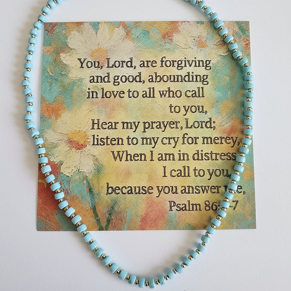 Turquoise beaded bracelet with a card featuring text on a light background