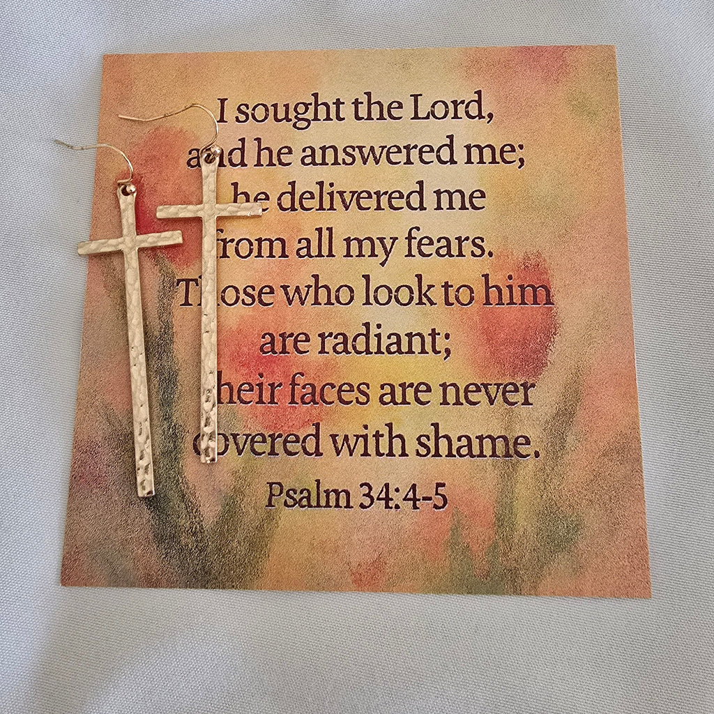 Decorative card with text and a cross on a textured surface