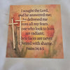 Decorative card with text and a cross on a textured surface