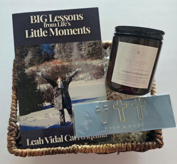 Basket with book 'BIG Lessons from Life's Little Moments'  candle, and decorative item on a light gray background. gift bundle