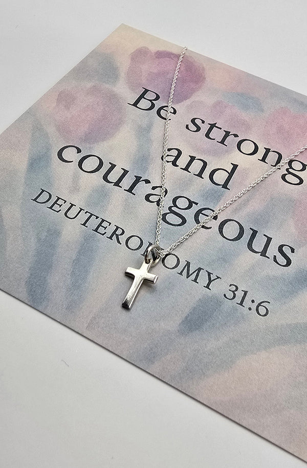 Silver cross necklace on a card with Br strong and courageous 