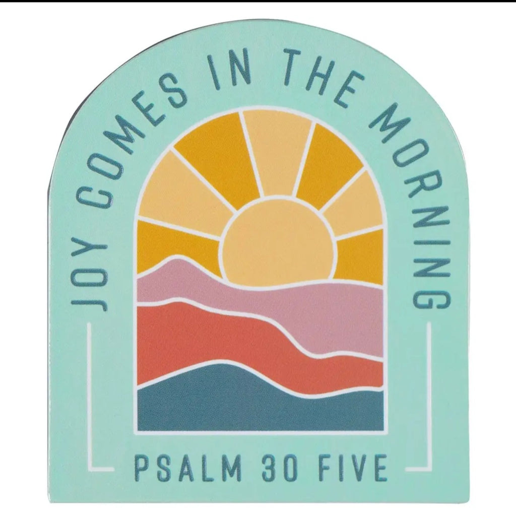 Decorative magnet with a sun and mountains design and text 'Joy Comes in the Morning Psalm 30 Five' on a light blue background.