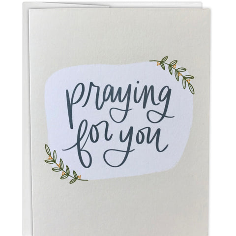 Greeting card with 'Praying for you' text on a white background