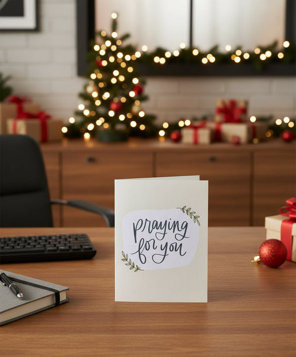 Greeting card with 'Praying for you' text on a white background