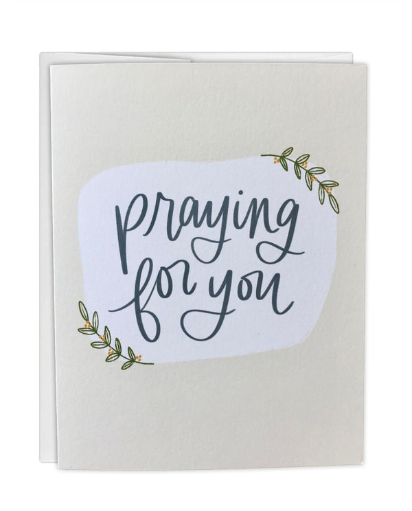 Greeting card with 'Praying for you' text on a white background