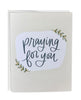 Greeting card with 'Praying for you' text on a white background