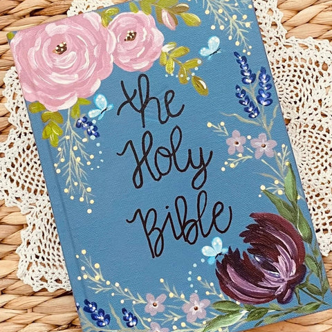 Decorative Bible cover with floral designs on a woven surface