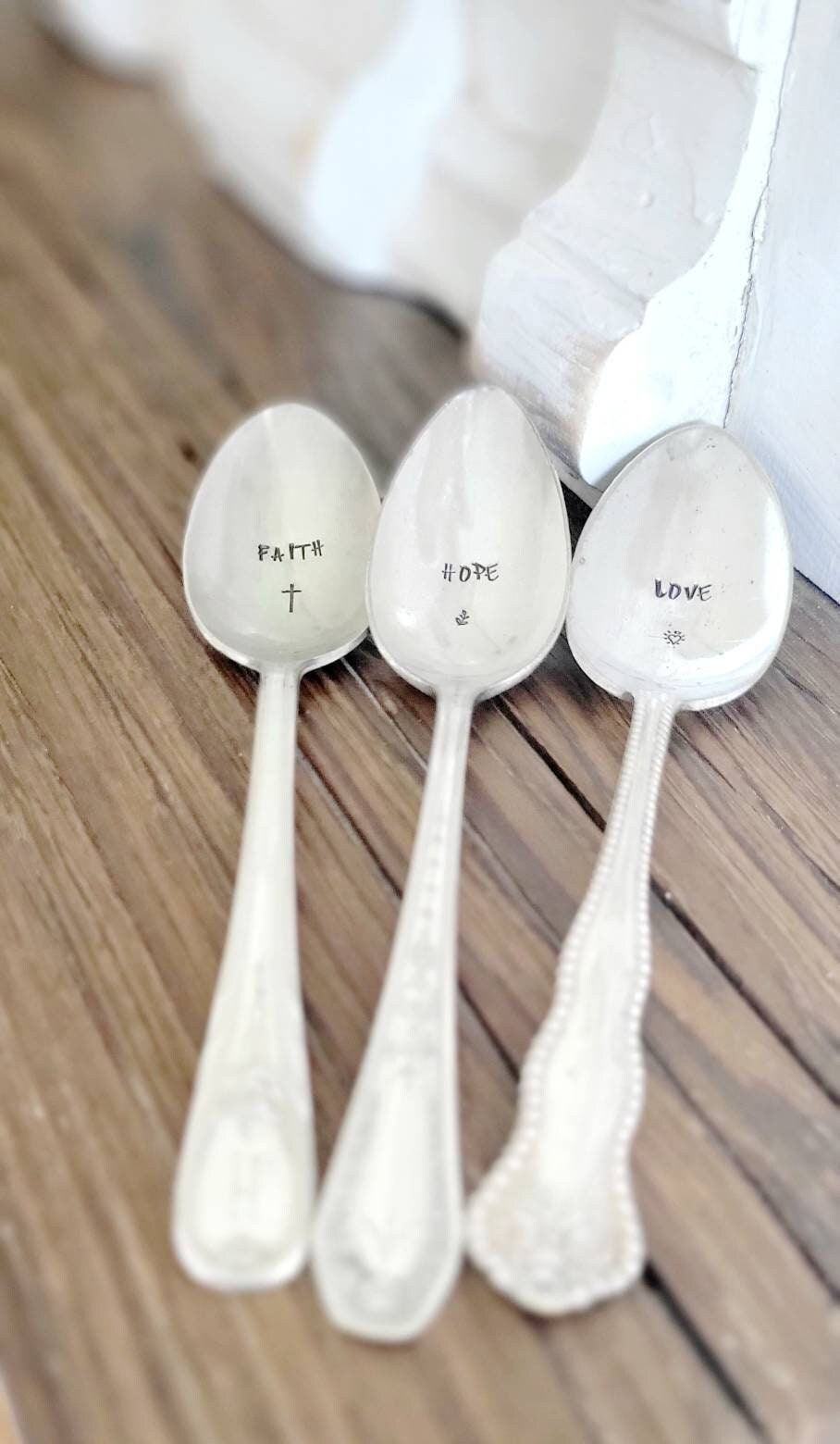 a set of vintage teaspoons each stamped with faith hope and love,all placed in a beautiful wandering tulips felt gift bag. each spoon will have a different pattern depending on what is in stock. if you would like to create your own please see custom